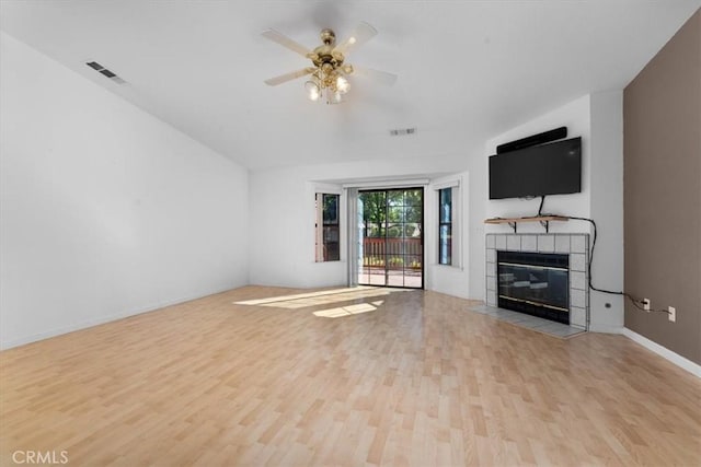 22022 Grove Cir, Red Bluff, CA 96080 - unfurnished living room with wood finished floors, a tile fireplace, a ceiling fan, and baseboards
