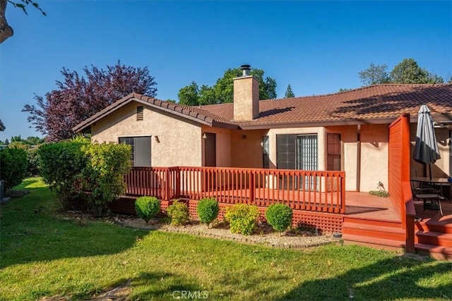 22022 Grove Cir, Red Bluff, CA 96080 - back of property with a chimney, stucco siding, a wooden deck, and a yard
