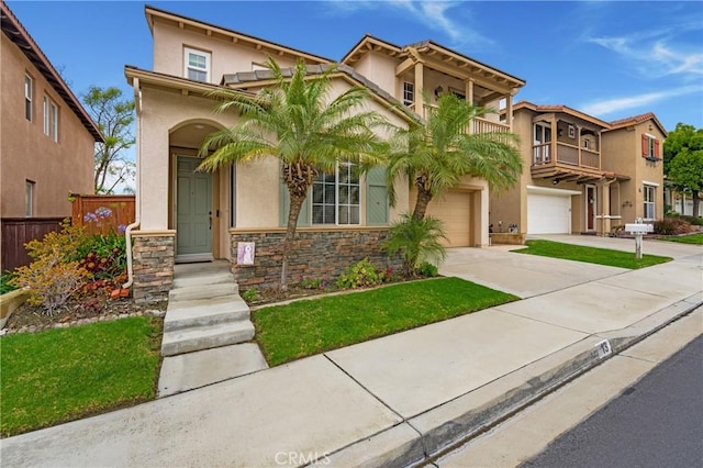 13 Arborside Way, Mission Viejo, CA 92692 - mediterranean / spanish home featuring concrete driveway, stucco siding, an attached garage, stone siding, and a balcony