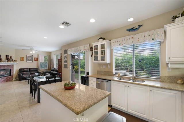 13 Arborside Way, Mission Viejo, CA 92692 - kitchen featuring a sink, stainless steel dishwasher, a center island, white cabinetry, and light tile patterned floors
