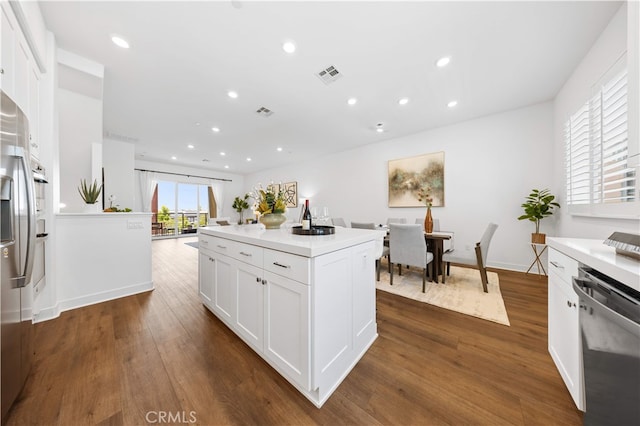150 Abacus, Irvine, CA 92618 - kitchen featuring appliances with stainless steel finishes, dark wood-style floors, white cabinetry, recessed lighting, and light countertops