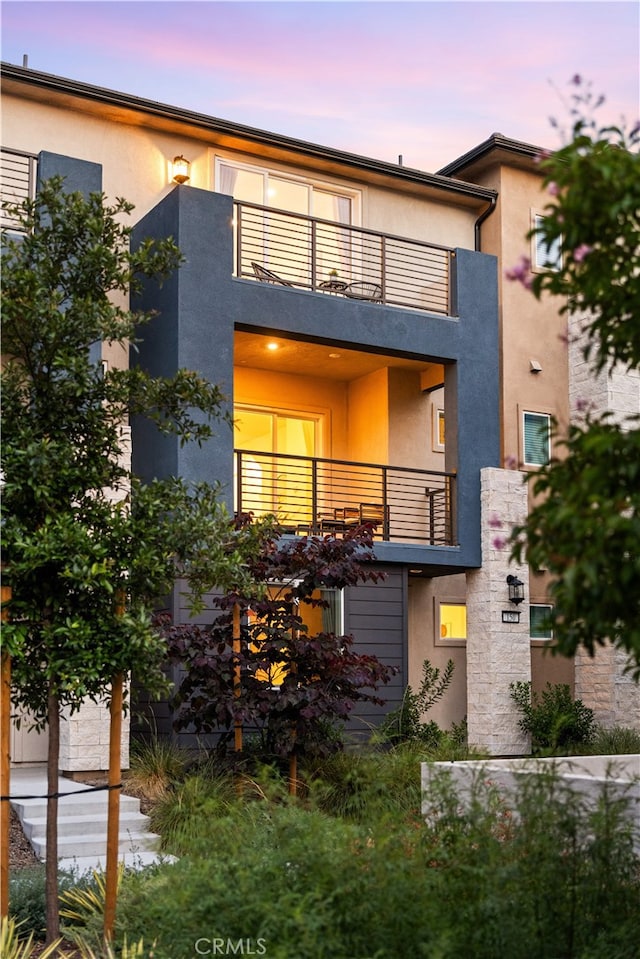 150 Abacus, Irvine, CA 92618 - back of house at dusk with a balcony and stucco siding