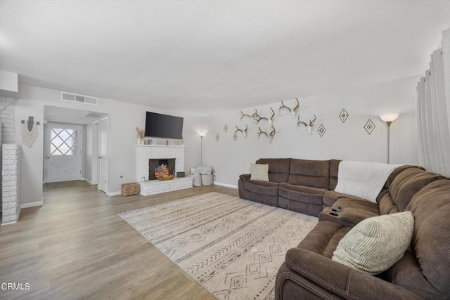 10217 Enger St, Bakersfield, CA 93312 - living room with light wood-style floors, a fireplace, and baseboards