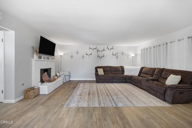 10217 Enger St, Bakersfield, CA 93312 - living room with wood finished floors, a fireplace, and baseboards