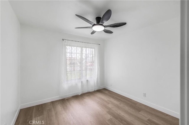10415 Mapledale St, Bellflower, CA 90706 - unfurnished room with ceiling fan, wood finished floors, and baseboards