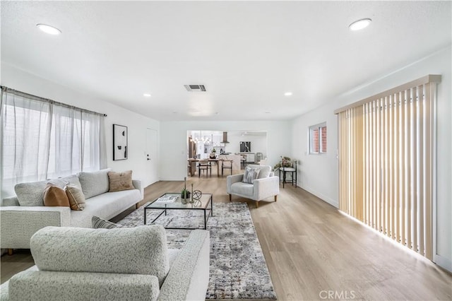 10415 Mapledale St, Bellflower, CA 90706 - living room featuring light wood finished floors, recessed lighting, and baseboards