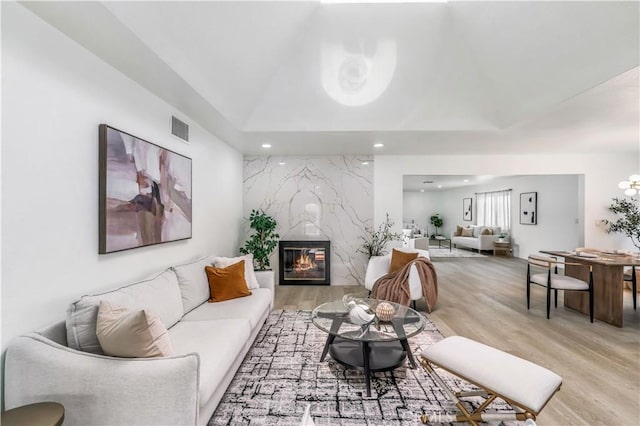 10415 Mapledale St, Bellflower, CA 90706 - living room featuring light wood-style floors, recessed lighting, and a premium fireplace
