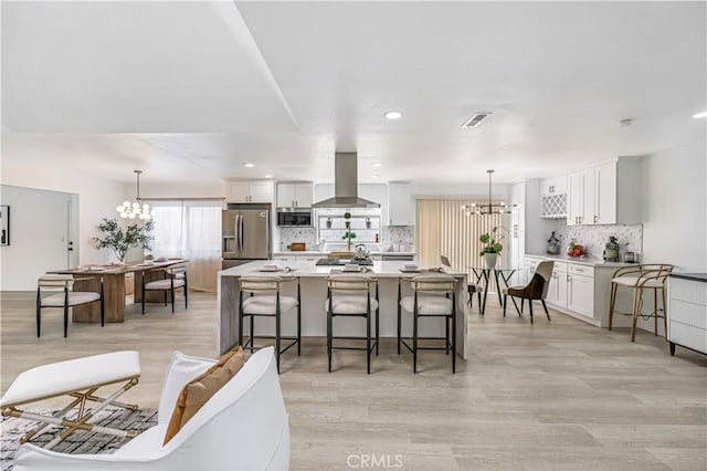 10415 Mapledale St, Bellflower, CA 90706 - living room with a chandelier, light wood-type flooring, and recessed lighting