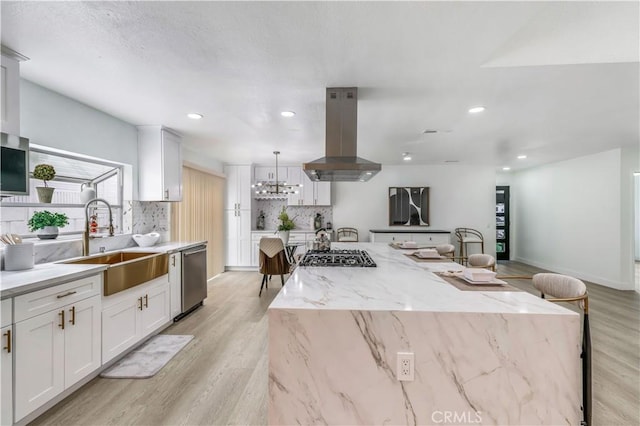 10415 Mapledale St, Bellflower, CA 90706 - kitchen featuring island exhaust hood, a sink, stainless steel dishwasher, light wood finished floors, and a center island