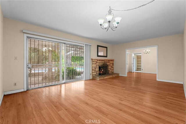 10120 Andasol Ave, Northridge, CA 91325 - unfurnished living room with a chandelier, wood finished floors, and baseboards
