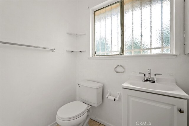 10120 Andasol Ave, Northridge, CA 91325 - half bath featuring toilet, vanity, baseboards, and tile patterned flooring