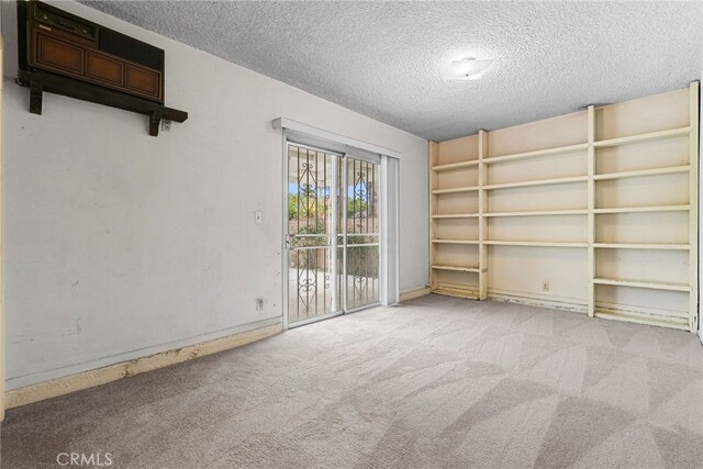 10120 Andasol Ave, Northridge, CA 91325 - spare room featuring a textured ceiling, carpet, and baseboards