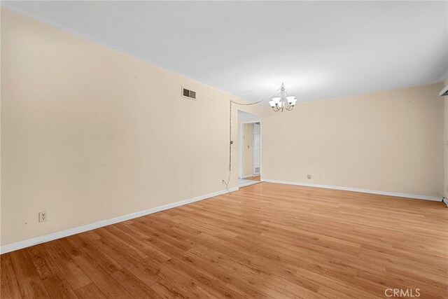10120 Andasol Ave, Northridge, CA 91325 - spare room featuring a chandelier, light wood-type flooring, and baseboards