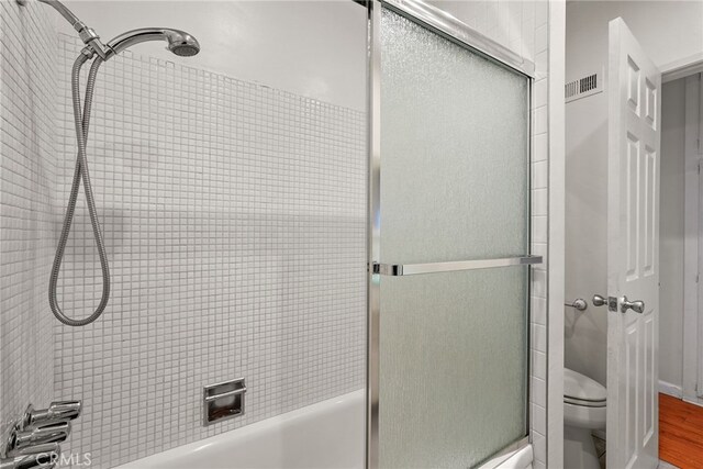 10120 Andasol Ave, Northridge, CA 91325 - bathroom featuring toilet, combined bath / shower with glass door, and wood finished floors
