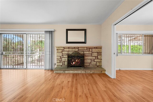 10120 Andasol Ave, Northridge, CA 91325 - unfurnished living room featuring wood finished floors, a fireplace, and baseboards