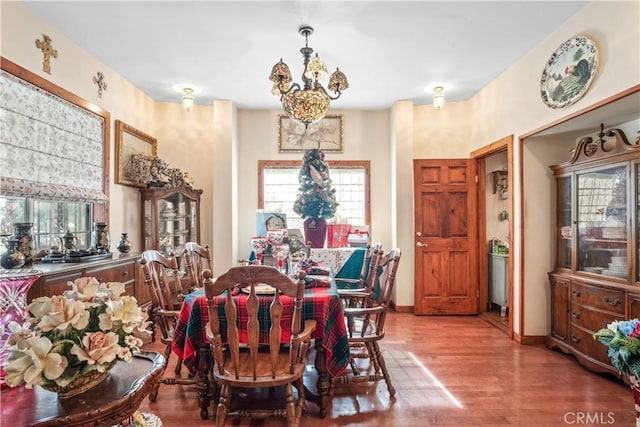 4611 S Gramercy Pl, Los Angeles, CA 90062 - dining room featuring wood finished floors and a chandelier