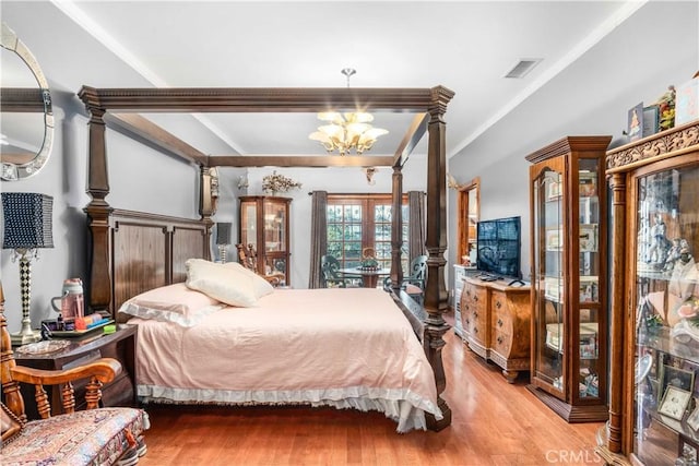 4611 S Gramercy Pl, Los Angeles, CA 90062 - bedroom featuring french doors, light wood-style flooring, ornamental molding, and a chandelier