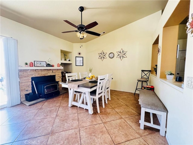 8925 Fallbrook Ct, Hesperia, CA 92344 - dining space with a ceiling fan, light tile patterned floors, and a wood stove