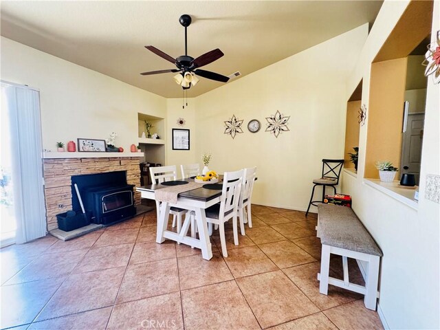 8925 Fallbrook Ct, Hesperia, CA 92344 - dining area with ceiling fan, light tile patterned floors, and a wood stove