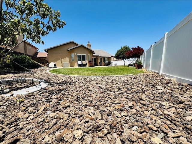 8925 Fallbrook Ct, Hesperia, CA 92344 - rear view of property with a fenced backyard and a chimney