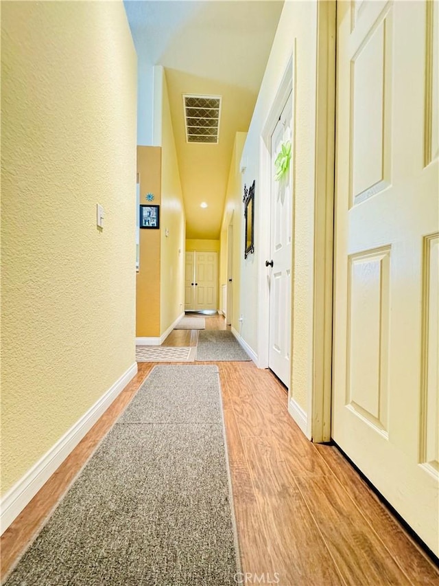 8925 Fallbrook Ct, Hesperia, CA 92344 - corridor with a textured wall and light wood-style floors