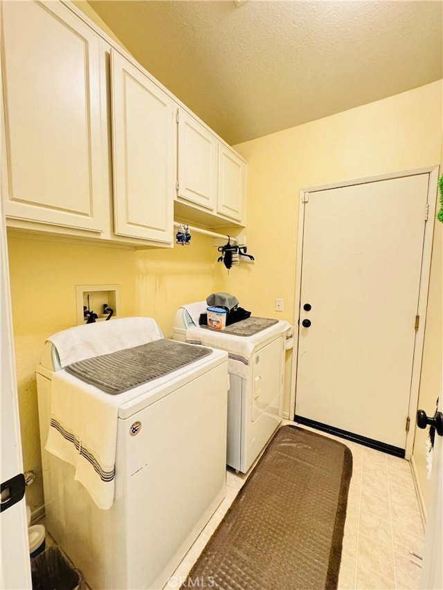 8925 Fallbrook Ct, Hesperia, CA 92344 - washroom featuring separate washer and dryer, cabinet space, light tile patterned flooring, and a textured ceiling