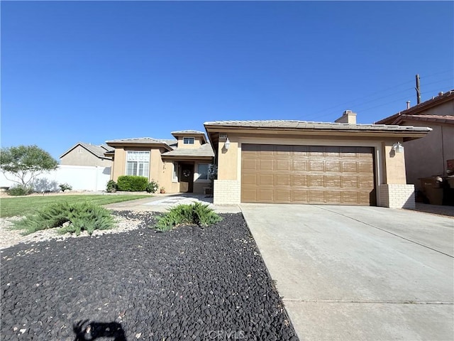 8925 Fallbrook Ct, Hesperia, CA 92344 - view of front of property with concrete driveway, brick siding, stucco siding, a garage, and a chimney