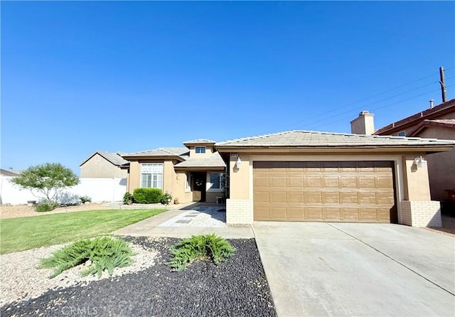 8925 Fallbrook Ct, Hesperia, CA 92344 - view of front facade featuring concrete driveway, stucco siding, a garage, and brick siding