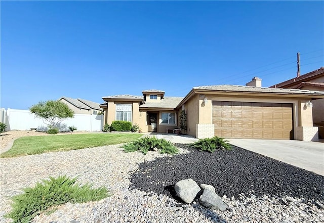 8925 Fallbrook Ct, Hesperia, CA 92344 - view of front of house featuring stucco siding, a garage, driveway, and brick siding