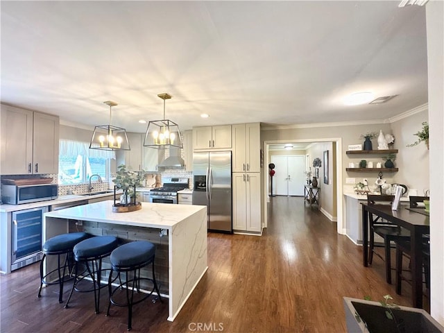 18839 Watson Ave, Cerritos, CA 90703 - kitchen with appliances with stainless steel finishes, beverage cooler, ornamental molding, a kitchen island, and tasteful backsplash
