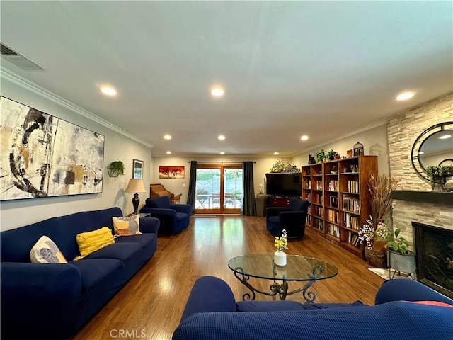 18839 Watson Ave, Cerritos, CA 90703 - living room featuring a stone fireplace, wood finished floors, recessed lighting, and crown molding