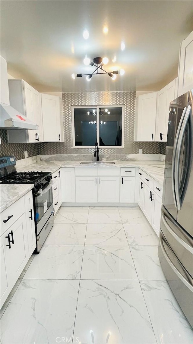 14940 Beckner St, La Puente, CA 91744 - kitchen with stainless steel appliances, a sink, light marble finish floors, and light stone counters