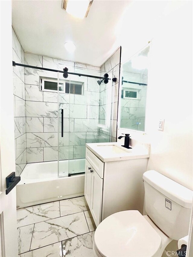 14940 Beckner St, La Puente, CA 91744 - bathroom with toilet, vanity, shower / bath combination with glass door, and marble look tile flooring