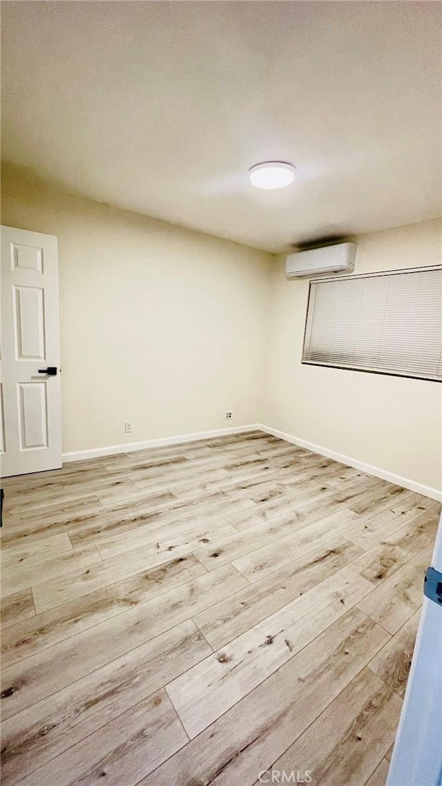 14940 Beckner St, La Puente, CA 91744 - basement featuring a wall mounted AC, light wood finished floors, and baseboards