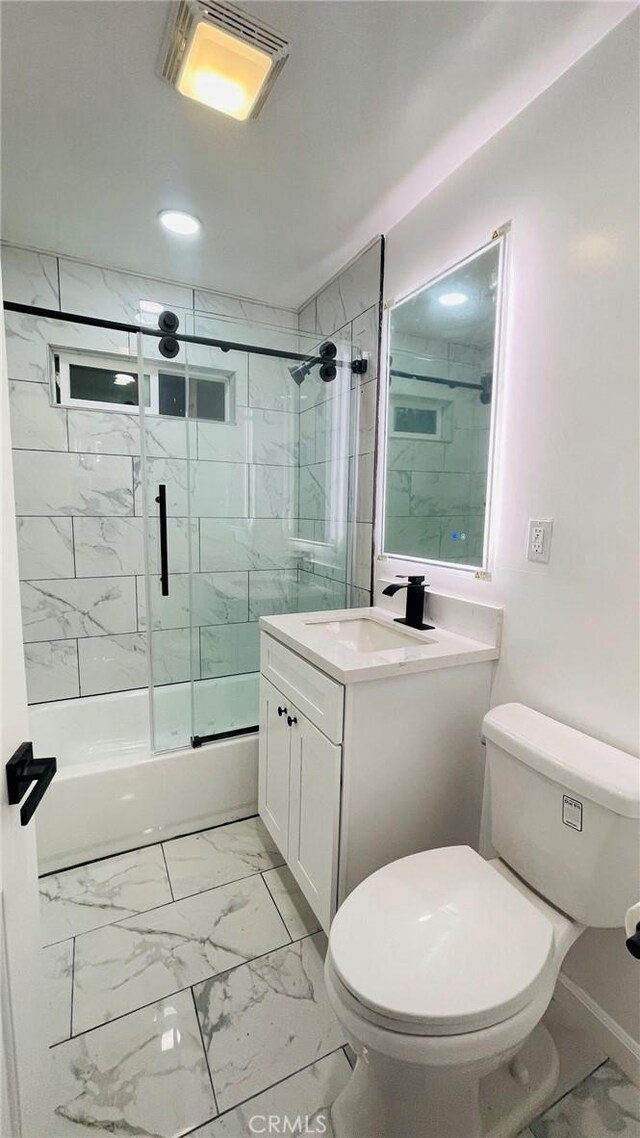 14940 Beckner St, La Puente, CA 91744 - full bath with marble look tiles, enclosed tub / shower combo, toilet, vanity, and recessed lighting
