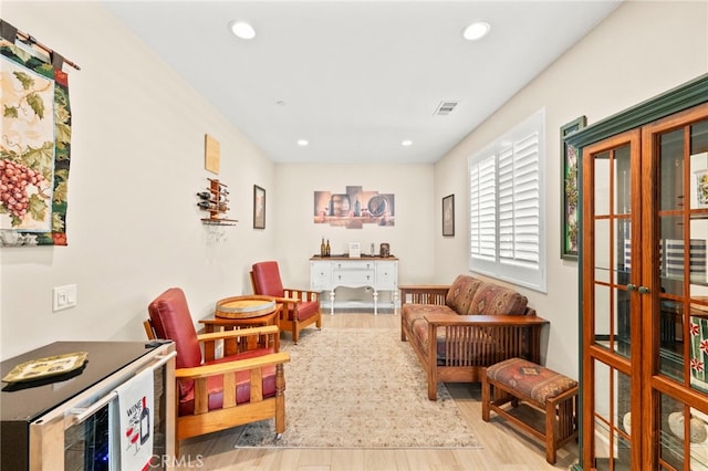34452 Turquoise Ln, Murrieta, CA 92563 - sitting room with french doors, wood finished floors, wine cooler, and recessed lighting