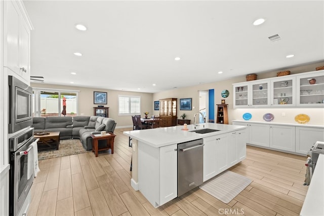 34452 Turquoise Ln, Murrieta, CA 92563 - kitchen with appliances with stainless steel finishes, a sink, light wood-type flooring, open floor plan, and recessed lighting