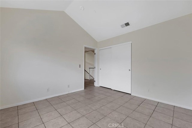 13421 Hubbard St Unit 125, Sylmar, CA 91342 - empty room featuring vaulted ceiling, light tile patterned floors, and baseboards
