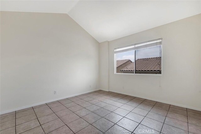 13421 Hubbard St Unit 125, Sylmar, CA 91342 - empty room featuring lofted ceiling, light tile patterned floors, and baseboards