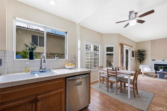 13421 Hubbard St Unit 125, Sylmar, CA 91342 - kitchen featuring stainless steel dishwasher, tile counters, light wood-style floors, and a ceiling fan