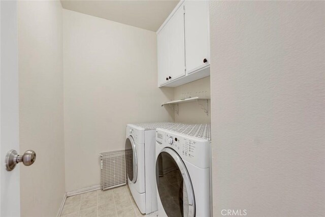 13421 Hubbard St Unit 125, Sylmar, CA 91342 - laundry area featuring independent washer and dryer, baseboards, and cabinet space