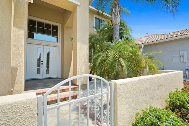 9406 Glenaire Ct, Rancho Cucamonga, CA 91730 - property entrance featuring french doors, stucco siding, and a gate