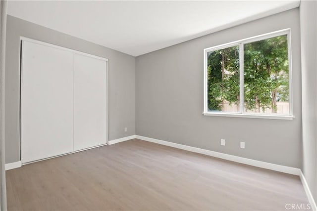 9406 Glenaire Ct, Rancho Cucamonga, CA 91730 - unfurnished bedroom featuring wood finished floors, baseboards, and a closet