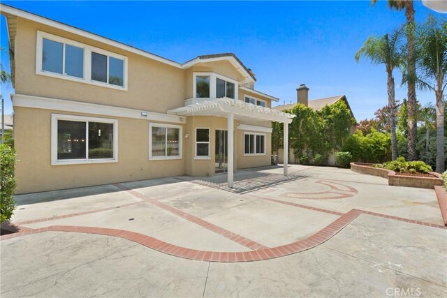 9406 Glenaire Ct, Rancho Cucamonga, CA 91730 - back of property with stucco siding, a pergola, and a patio