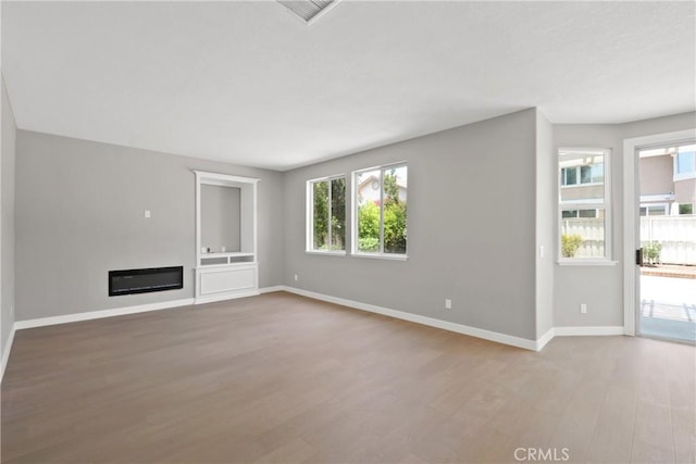 9406 Glenaire Ct, Rancho Cucamonga, CA 91730 - unfurnished living room with wood finished floors, baseboards, and a glass covered fireplace