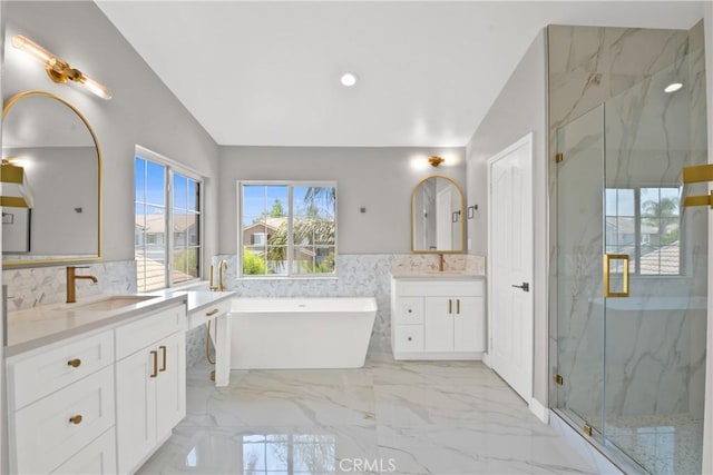 9406 Glenaire Ct, Rancho Cucamonga, CA 91730 - full bathroom featuring a marble finish shower, two vanities, a freestanding bath, a wainscoted wall, and marble tiled flooring