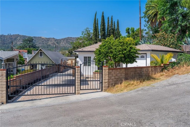 2035 Las Colinas Ave, Los Angeles, CA 90041 - obstructed view of property with a gate, a mountain view, and stucco siding