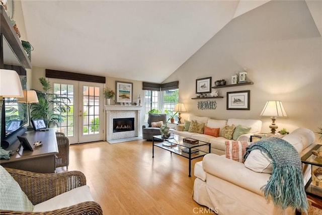 543 Rockport Ct, Encinitas, CA 92024 - living area featuring wood finished floors, high vaulted ceiling, a fireplace, and french doors