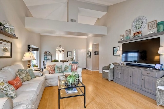 543 Rockport Ct, Encinitas, CA 92024 - living area with a chandelier, high vaulted ceiling, light wood-type flooring, and baseboards