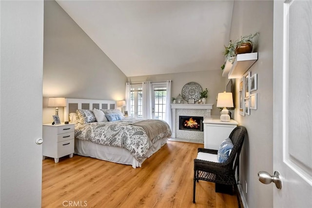 543 Rockport Ct, Encinitas, CA 92024 - bedroom with light wood-style flooring, a warm lit fireplace, and high vaulted ceiling